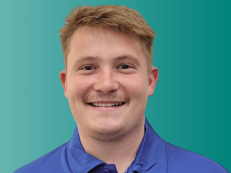 Portrait Photo of Oscar wearing a Worldwide Express branded polo shirt
